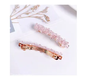 Pink crystal hair clip detail view showing delicate beaded design and golden metal spring barrette.