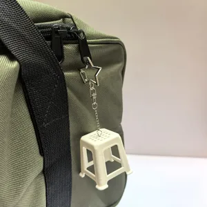 Miniature stool keychain detail shot, creative retro novelty bag hanging ornament.