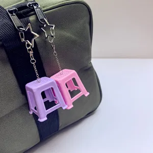Miniature plastic stool keychain detail shot, creative bag charm pendant with star hook.