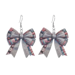 Close-up detail shot of wooden bow earrings featuring unique book pattern, retro school style.