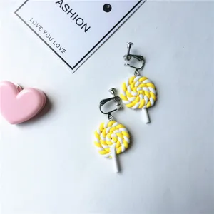Yellow white swirl lollipop clip-on earrings cute sweet candy ear clips detail view