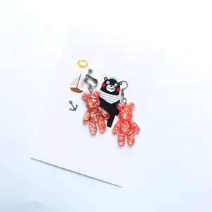 Detailed closeup of glitter resin bear earrings, sparkling design with secure metal clasps.