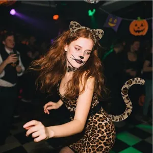 Leopard costume detail shot featuring cute cat ears headband, choker and fuzzy tail for party.