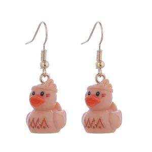 Detailed close-up of cute resin duck earrings with fishhook design, charming and playful.