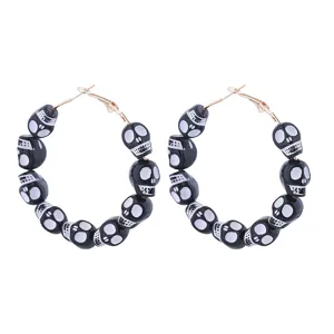 Gothic Halloween skull bead hoop earrings, unique black and white statement jewelry detail.