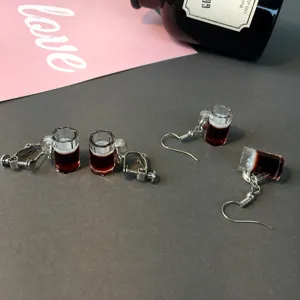 Close-up detail of mini beer mug earrings and clip-ons, funny novelty jewelry design.