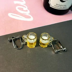 Detailed shot of cute novelty beer mug clip-on earrings, quirky resin design for women.