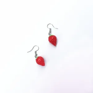 Close-up detail of cute red strawberry drop earrings, sweet design for summer daily wear style.