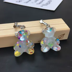 Cute handmade glitter bear resin clip-on earrings close-up detail showcasing colorful sequins.