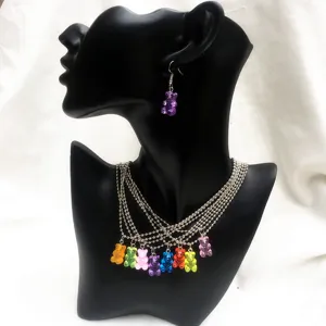 Detailed shot of colorful jelly resin bear necklace and matching earring set on display.