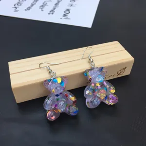 Detailed view of cute purple resin glitter bear dangle earrings, lovely handmade jewelry design.
