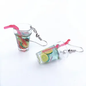 Detailed view of creative miniature fruit lemon tea cup earrings, fun resin dangle jewelry.