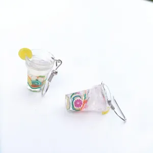 Miniature fruit tea cup earring detail, clear resin material with cute fruit slices.