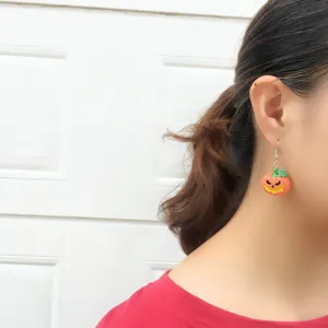 Halloween spooky pumpkin drop earrings detail view, cute resin charm jewelry for festival party.