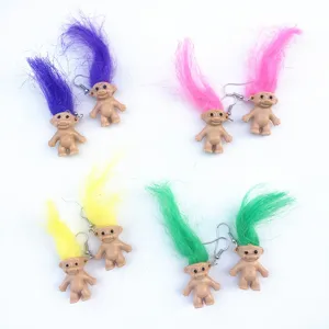 Detailed close-up of colorful vintage troll doll earrings with bright hair, retro quirky fashion style.