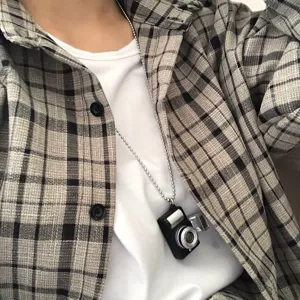Detailed view of a vintage mini camera pendant necklace, streetwear accessory with light and sound.