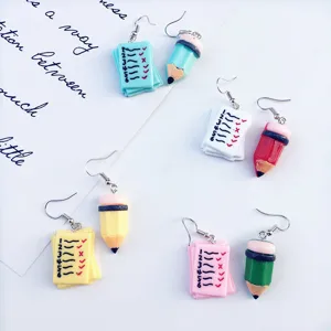 Cute creative asymmetrical earrings featuring adorable pencil and checklist designs for students.