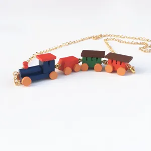 Vue de détail du collier train en bois mignon, pendentif blocs colorés avec chaîne dorée femme.