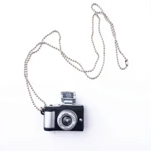 Retro mini camera pendant necklace detail view, showcasing intricate lens and flash design.