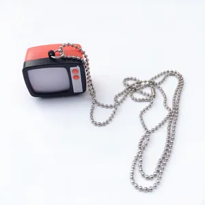 Detailed close-up shot of the vintage miniature retro television pendant on silver ball chain.