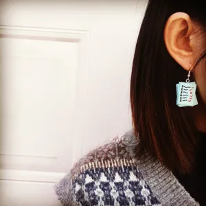 Detailed close-up view of quirky handmade test paper design dangling earring showing cute student style.
