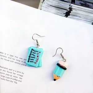Handmade quirky asymmetric earrings featuring cute paper checklist and blue pencil