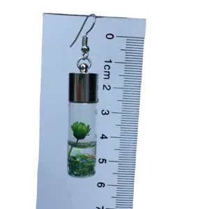 Fashion glass bottle earrings with green flower and glitter, unique drop earrings for daily wear.