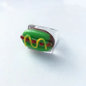 Close-up detail of the fun transparent acrylic ring featuring a quirky novelty food charm.