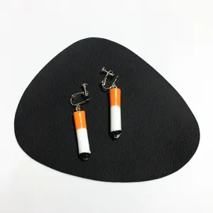 Detail view of creative handmade cigarette clip earrings with unique punk style design.