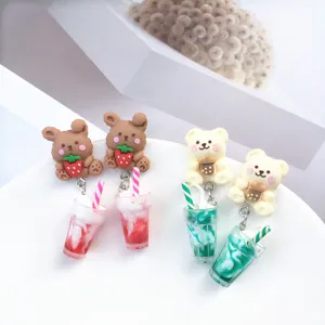 Gros plan détaillé de jolies boucles d'oreilles mignons en résine lapin fraise et thé.