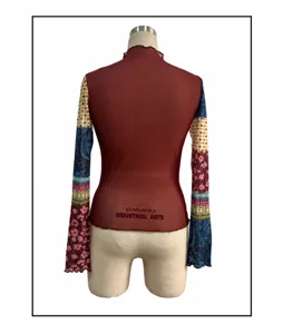Detailed back view of women's long sleeve mesh top featuring colorful patchwork floral print.