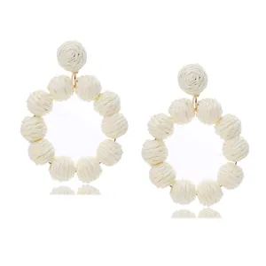White raffia woven ball drop earrings, summer beach vacation style rattan statement jewelry.