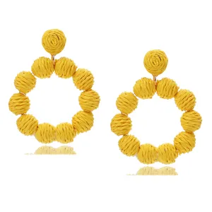 Exquisite yellow raffia woven round statement earrings, perfect for summer beach vacation style.