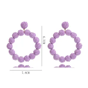 Detailed view showing dimensions of the handmade purple straw woven round earrings for summer.