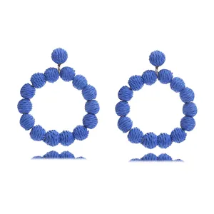 Handcrafted straw woven round ball earrings for summer beach vacation bohemian style.