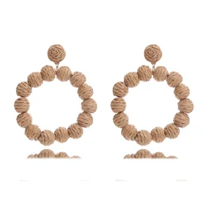 Boho handmade straw woven round ball earrings for summer beach vacation and street style.