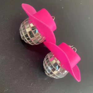 Pink cowboy hat disco ball earrings 70s rave disco punk style fashion jewelry detail view.