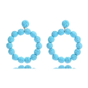 Handmade blue woven rattan round earrings, summer bohemian beach vacation jewelry piece.