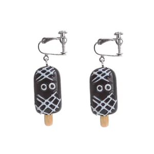 Close-up detail of cute Halloween popsicle resin clip-on earrings with funny cartoon eyes.