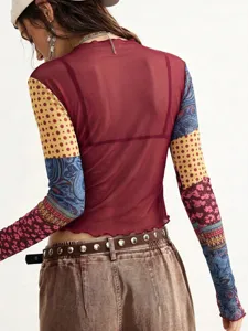 Close-up back view of sheer mesh patchwork long sleeve top with vintage print and lettuce hem.