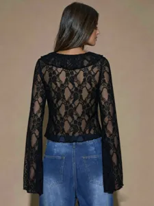 Detailed view of the elegant black lace long sleeve top showing delicate sheer fabric pattern.