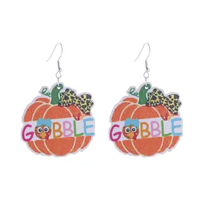 Close-up details of Thanksgiving wooden pumpkin turkey earrings with retro leopard style.
