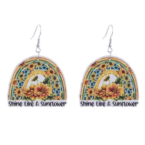 Detailed view of wooden sunflower rainbow dangle earrings with unique printed design.