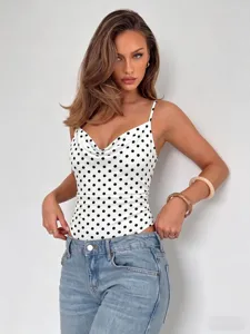 Detailed view of the black and white polka dot cowl neck camisole bodysuit worn by model.