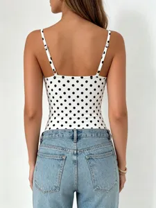 Back detail shot of women polka dot camisole bodysuit paired with casual blue denim jeans.