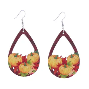 Autumn wooden teardrop earrings with cute pumpkin and maple leaf print for fall holiday season.
