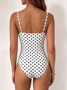 Detailed back view of women's black and white polka dot one piece swimsuit design.
