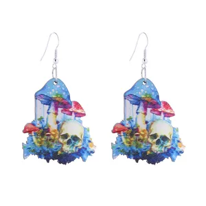 Detailed shot of unique wooden drop earrings featuring colorful mushroom and skull design.