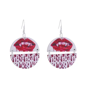 Detailed view of Halloween vampire lips and blood drop wooden earrings with silver hooks.