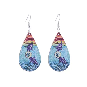 Halloween wooden teardrop earrings detail, gothic eyeball and bat wing design, unique jewelry.